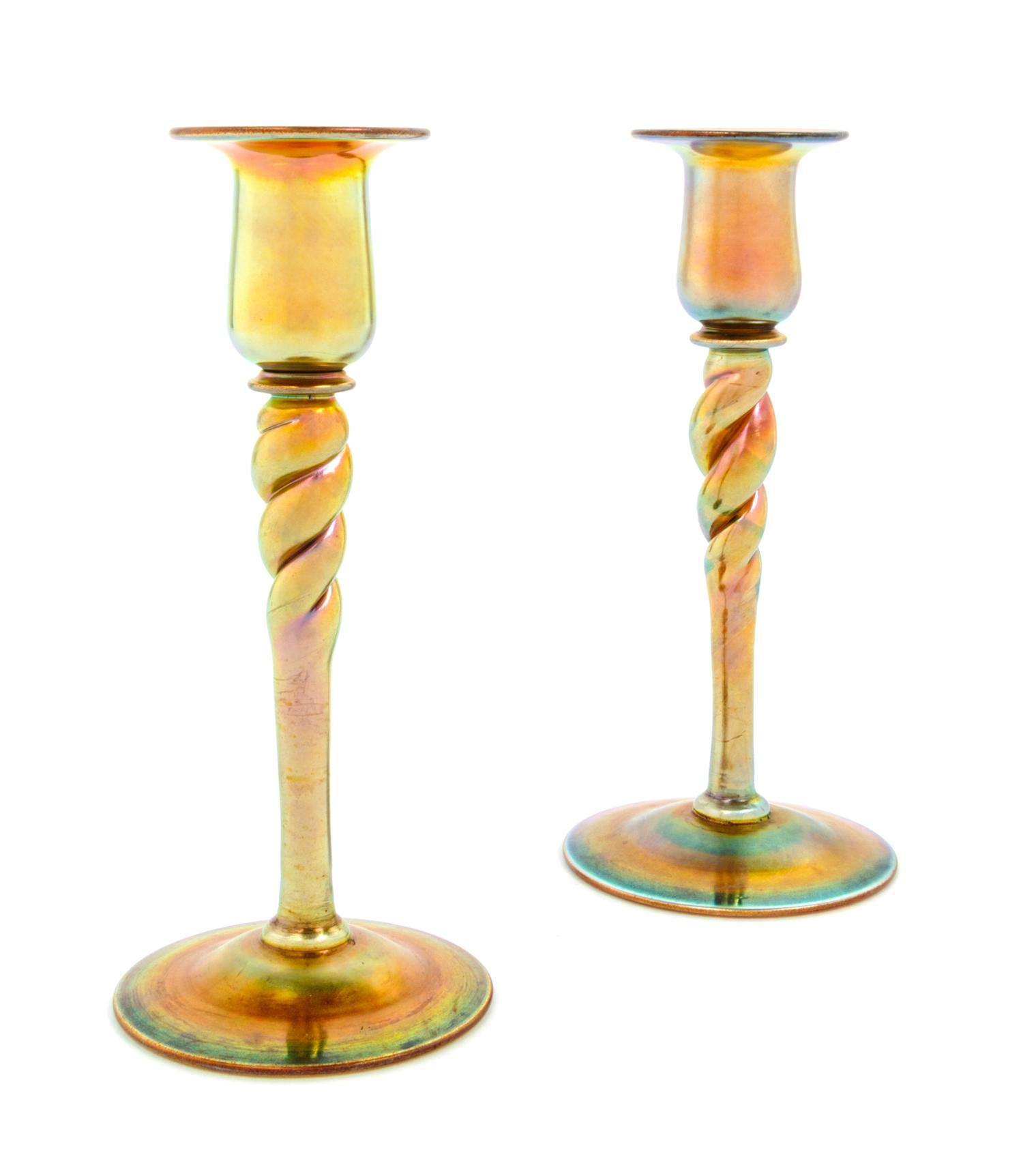 Steuben, EARLY 20TH CENTURY, a pair of Aurene glass candlesticks, each of baluster form with twisted stem in gold iridescence