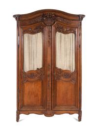 A Louis XV Provincial Style Carved Walnut Armoire