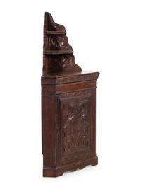 A Renaissance Revival Carved Oak Corner Cabinet