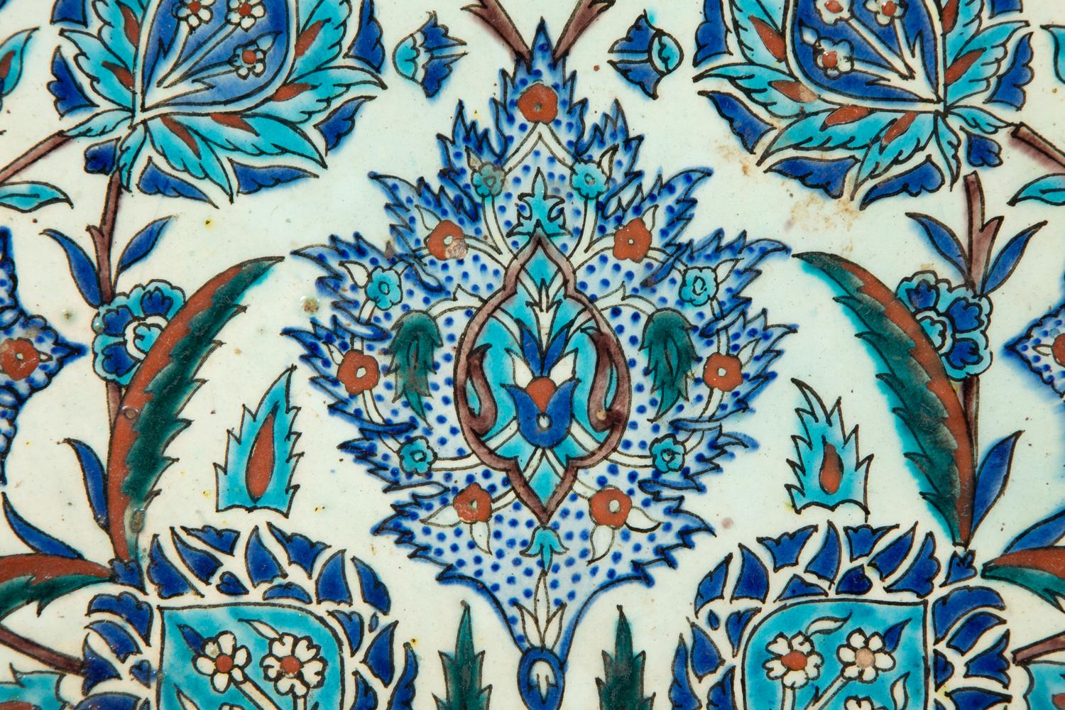 An Islamic Iznik Glazed Pottery Plate and a Small Vase