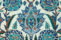 An Islamic Iznik Glazed Pottery Plate and a Small Vase