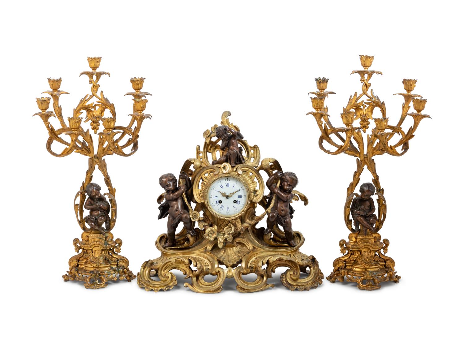 A Louis XV Style Gilt and Patinated Bronze Clock Garniture