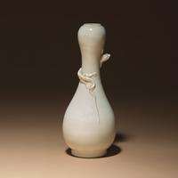 A Chinese White Glazed Porcelain 'Chilong' Bottle Vase, Qing Dynasty — 清 白釉盤螭龍瓶