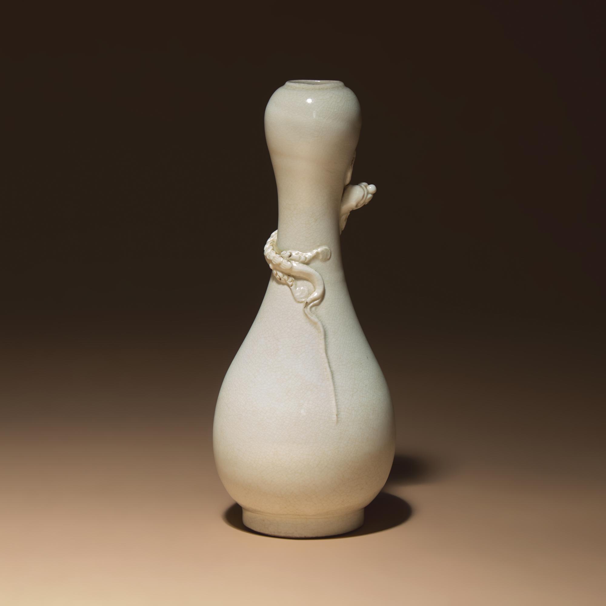 A Chinese White Glazed Porcelain 'Chilong' Bottle Vase, Qing Dynasty — 清 白釉盤螭龍瓶