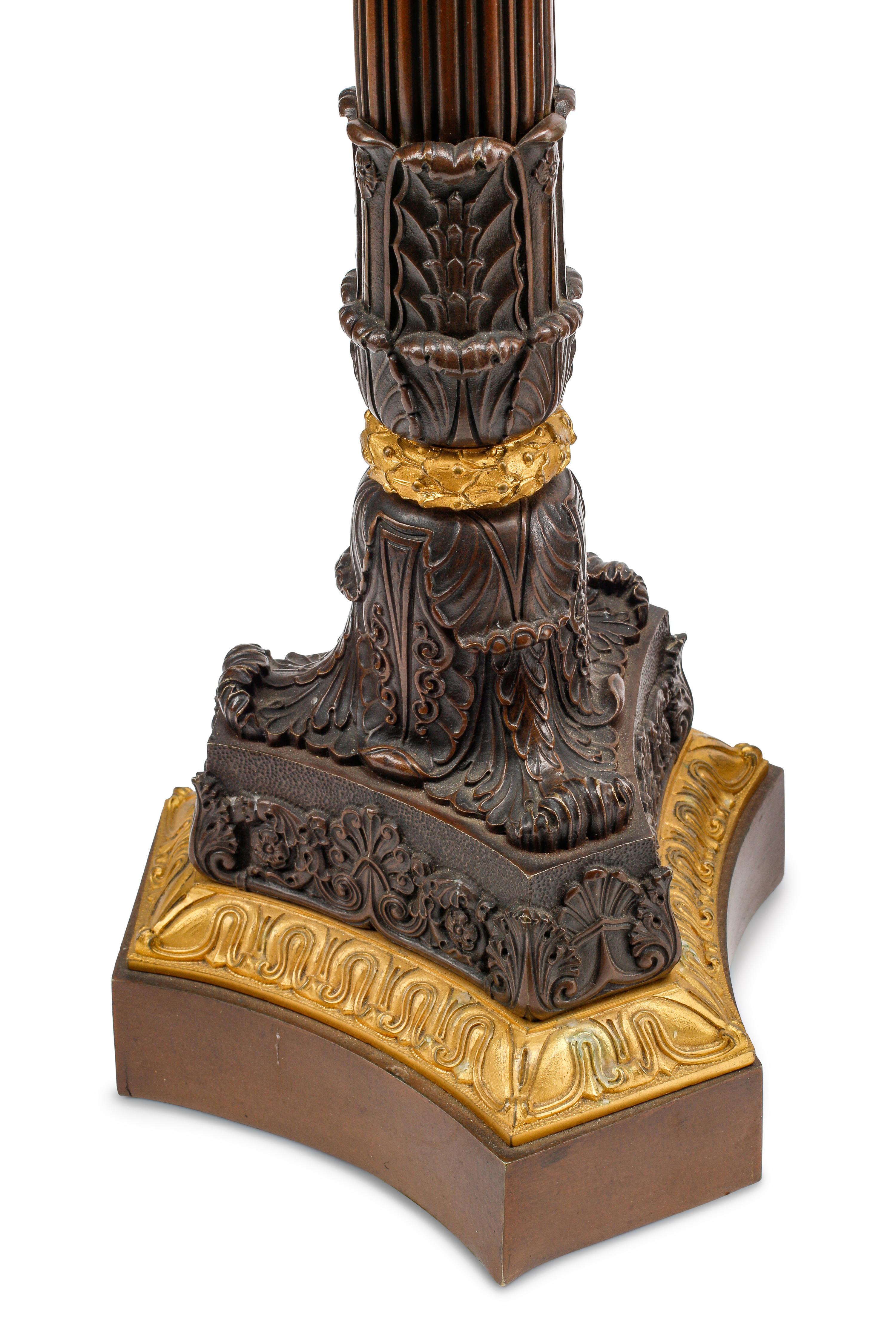 An Empire Style Gilt and Patinated Three-Piece Clock Garniture