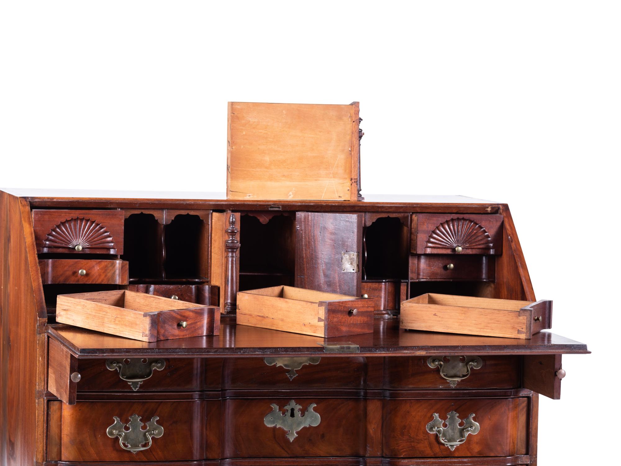 A Chippendale Carved and Figured Mahogany Block-Front Slant-Front Desk