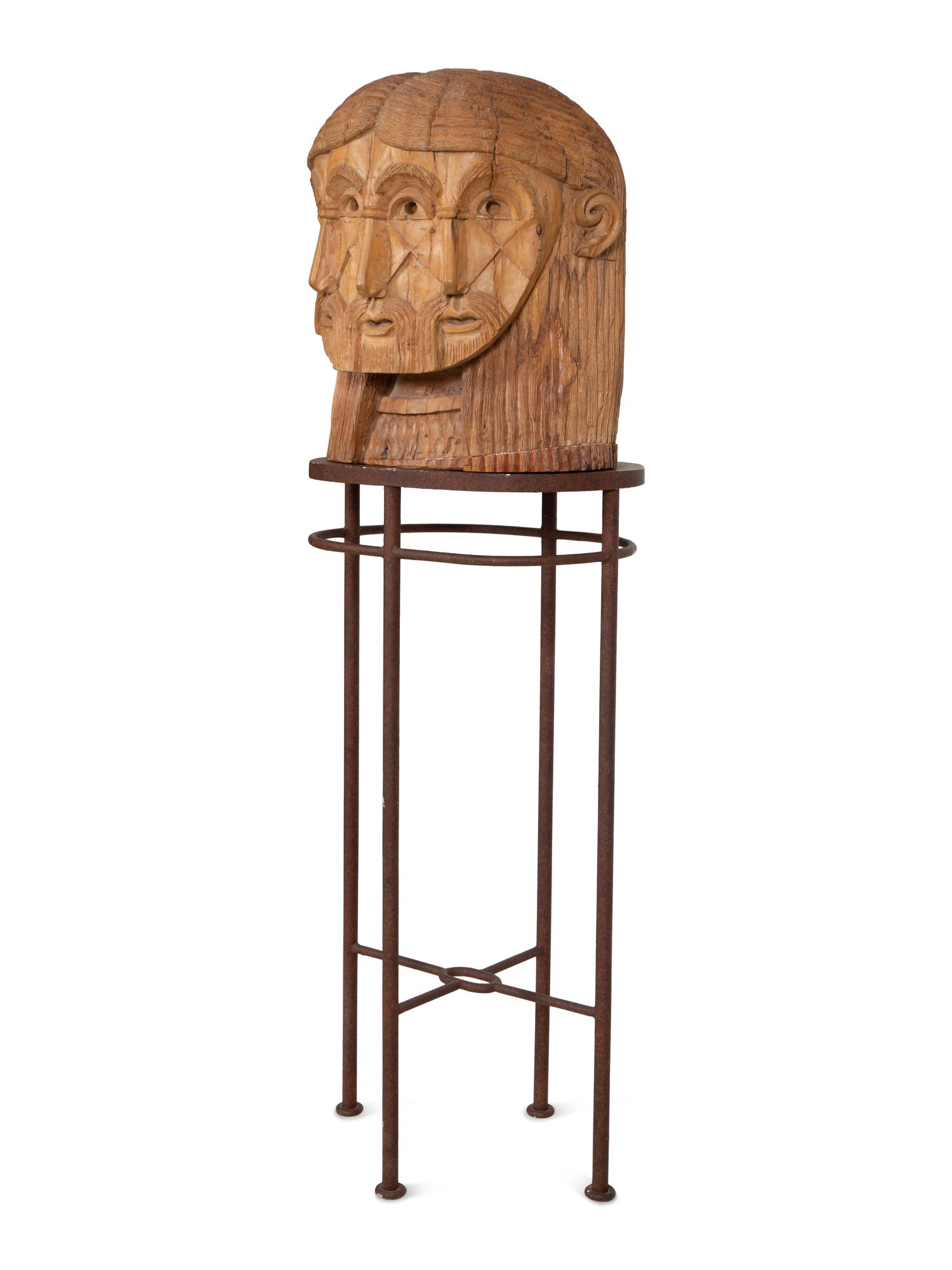 A Carved Wood Sculpture of a Three-Faced Man