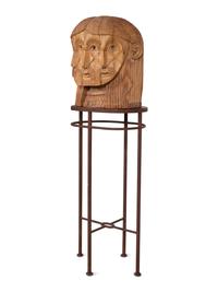 A Carved Wood Sculpture of a Three-Faced Man