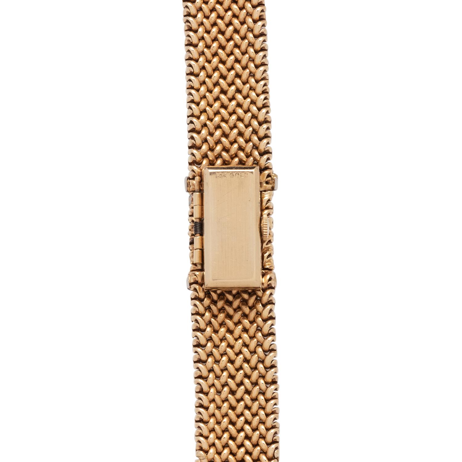 OLGA TRITT, YELLOW GOLD AND DIAMOND SURPRISE WATCH