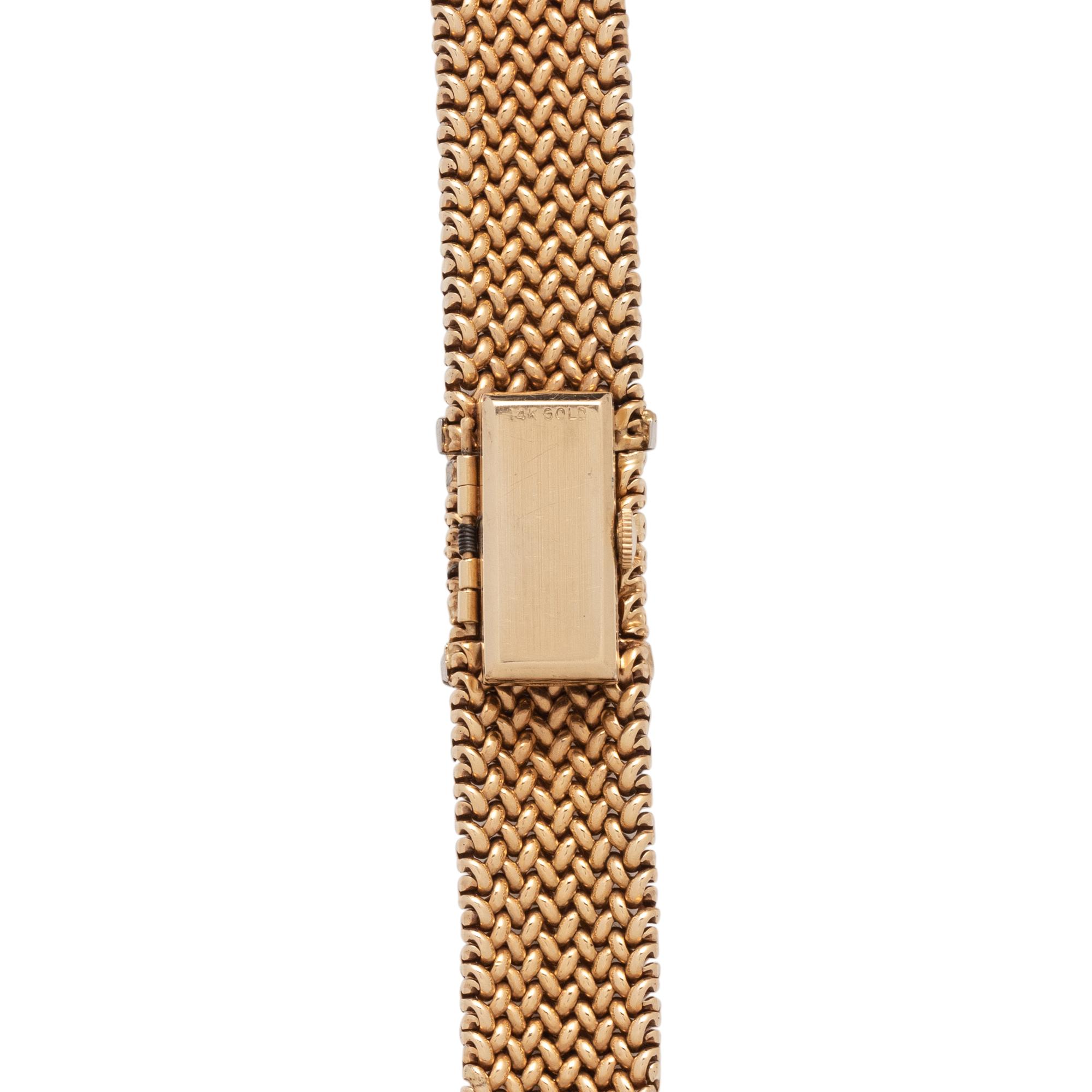 OLGA TRITT, YELLOW GOLD AND DIAMOND SURPRISE WATCH