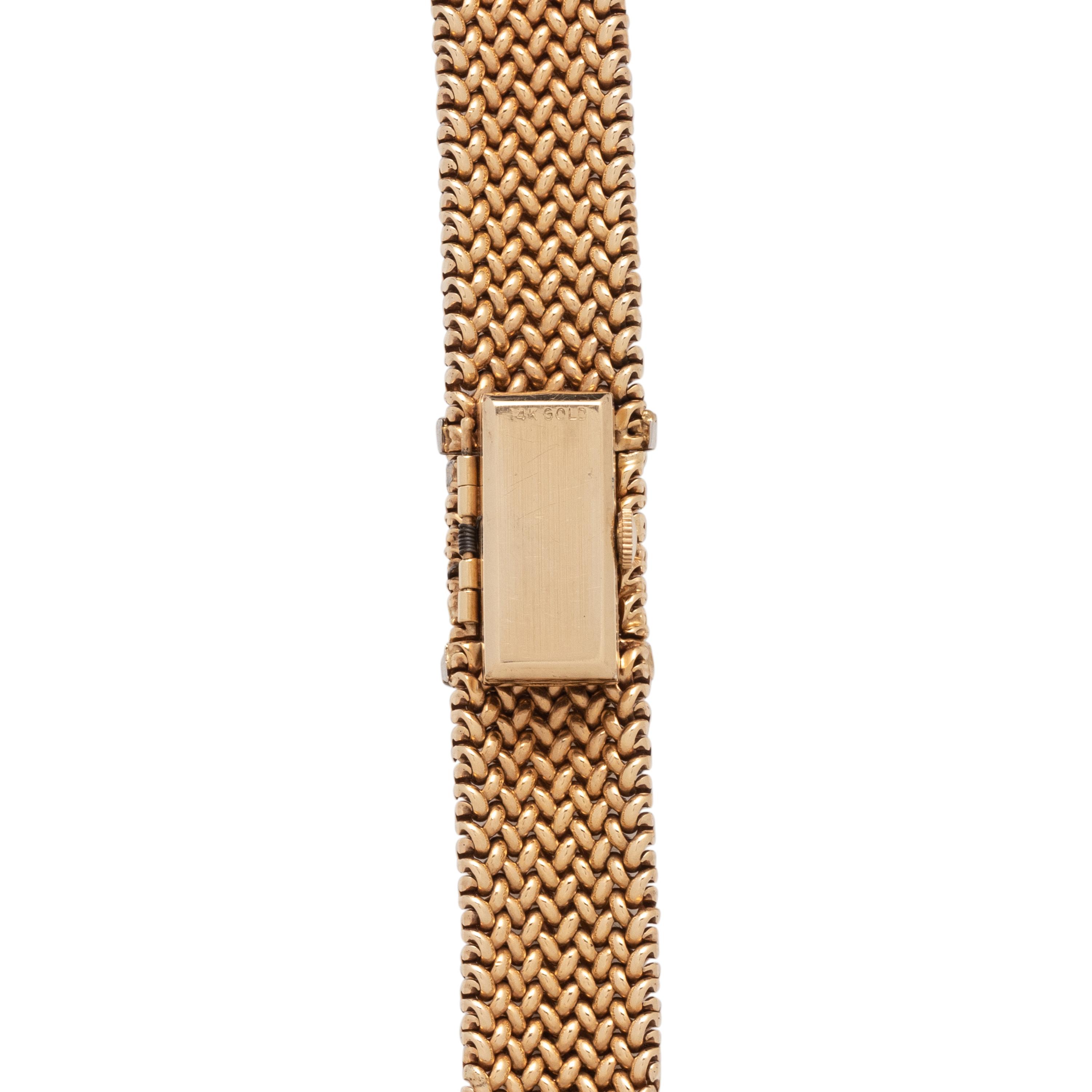 OLGA TRITT, YELLOW GOLD AND DIAMOND SURPRISE WATCH