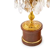 A Pair of Régence Style Rock Crystal, Cut Glass and Engraved Gilt Bronze Six-Light Candelabra on Simulated Porphyry Bases
