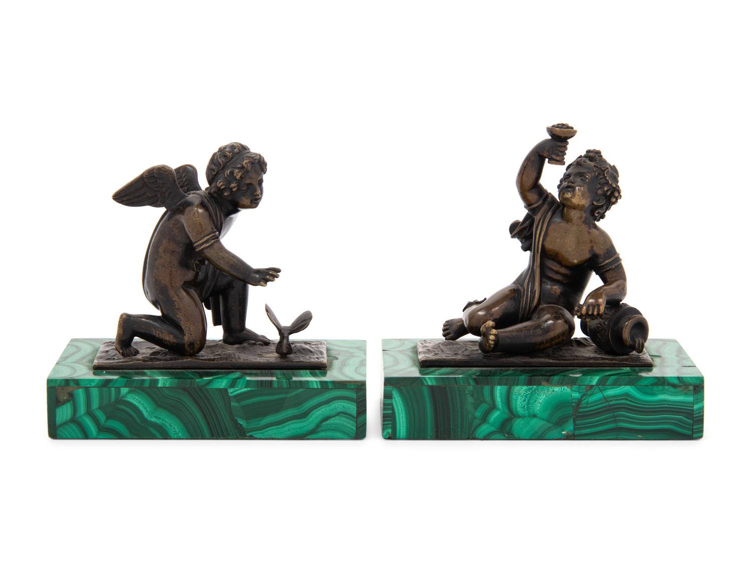 A Pair of Bronze Figures of Kneeling Putti