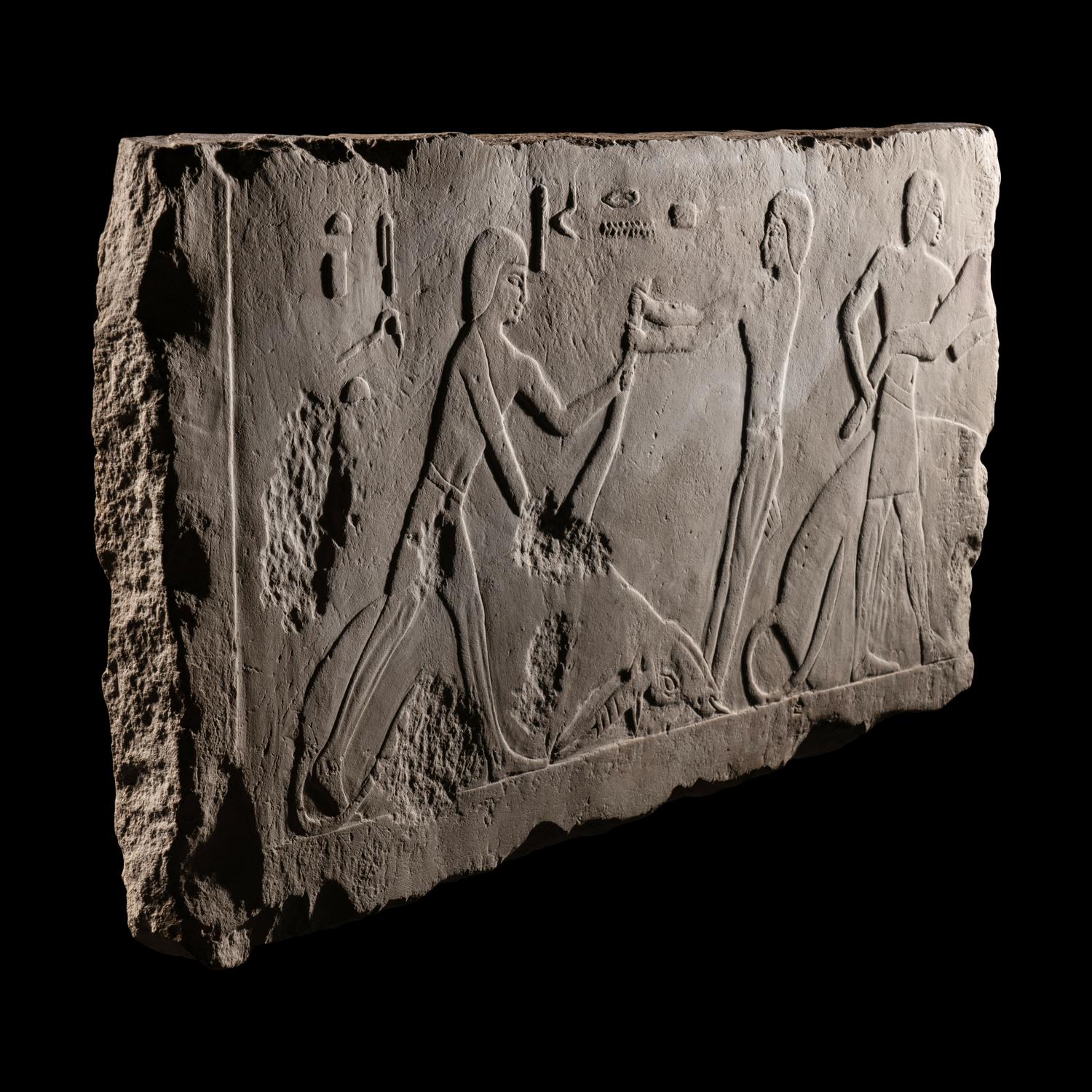 An Egyptian Limestone Relief Depicting Butchers