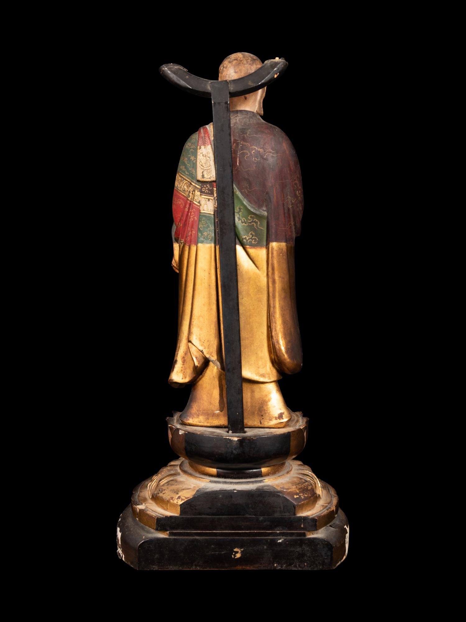 A Polychrome and Gilt Painted Wood Figure of a Standing Monk