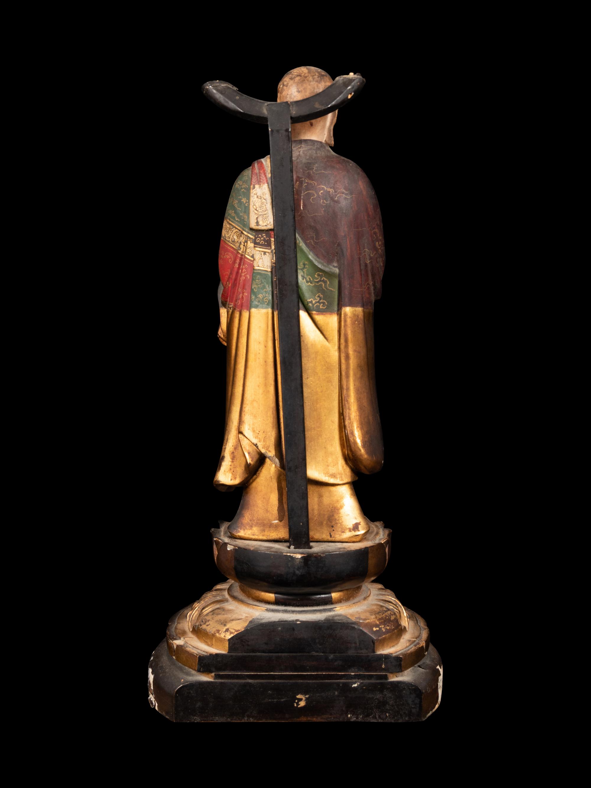 A Polychrome and Gilt Painted Wood Figure of a Standing Monk