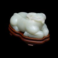 A Chinese Pale Celadon Jade Figure of a Recumbent Buffalo, Qing Dynasty 清 青玉臥牛