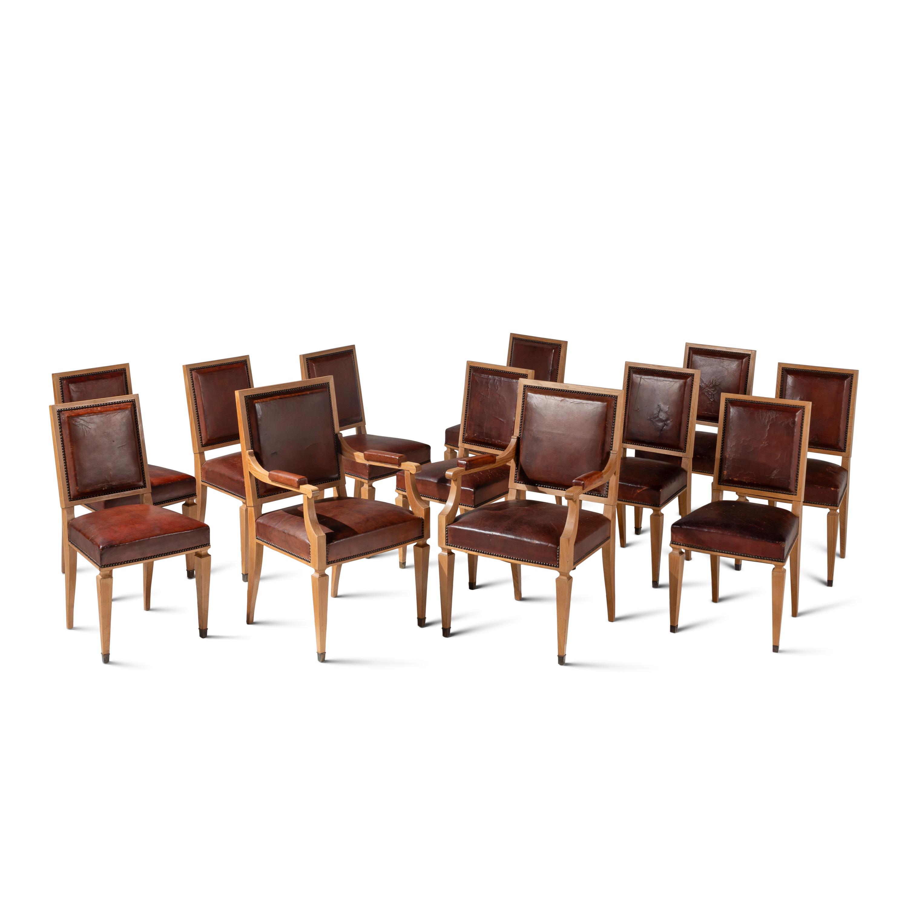A Set of Twelve Leather-Upholstered Cerused Oak Dining Chairs