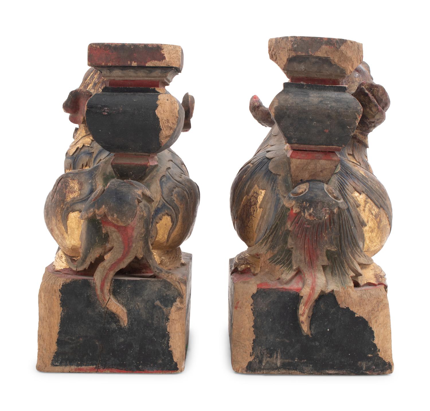 A Pair of Chinese Giltwood Candlesticks with Buddhistic Lions