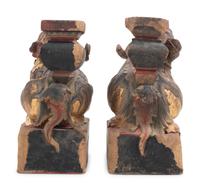 A Pair of Chinese Giltwood Candlesticks with Buddhistic Lions