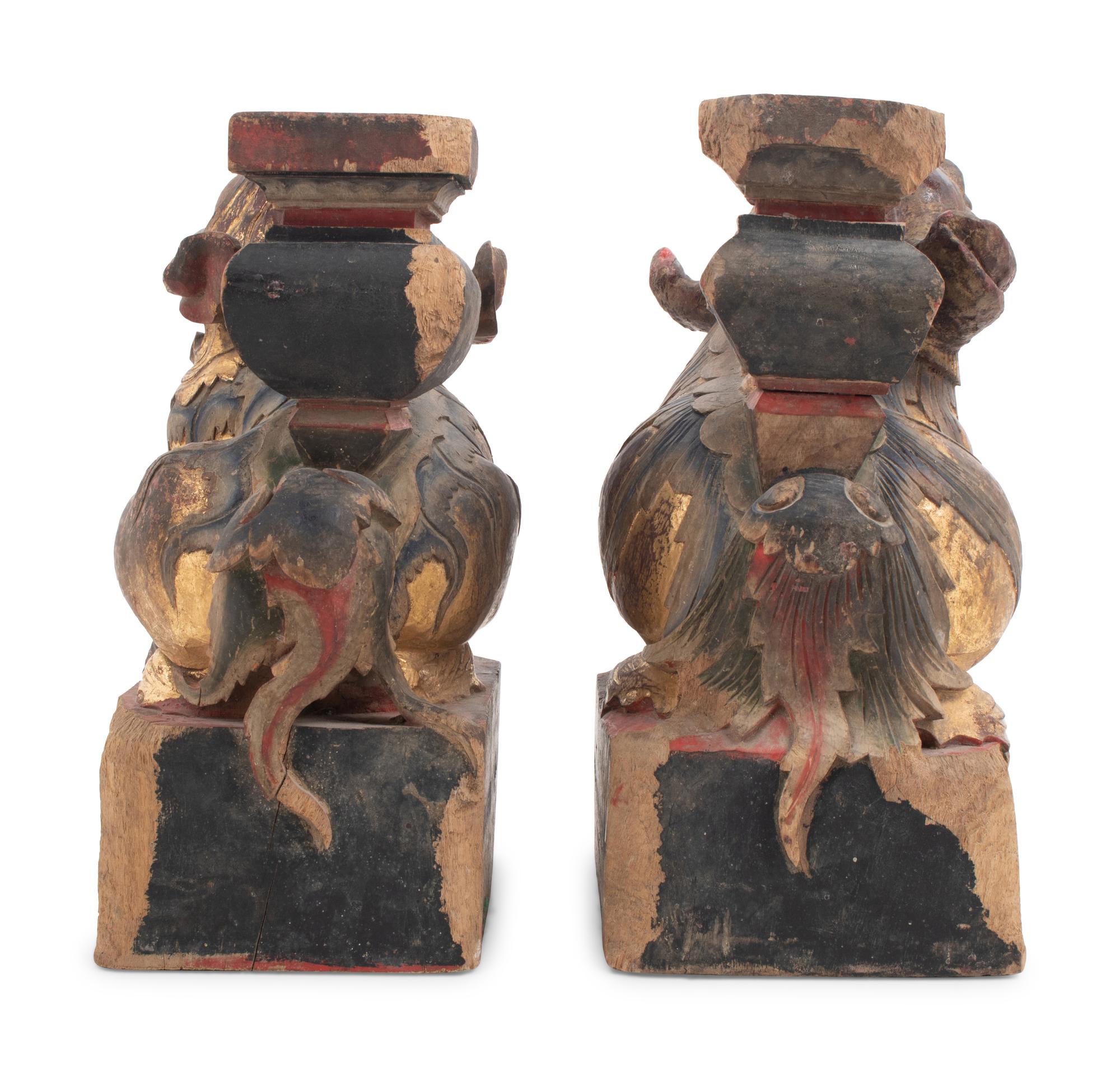 A Pair of Chinese Giltwood Candlesticks with Buddhistic Lions