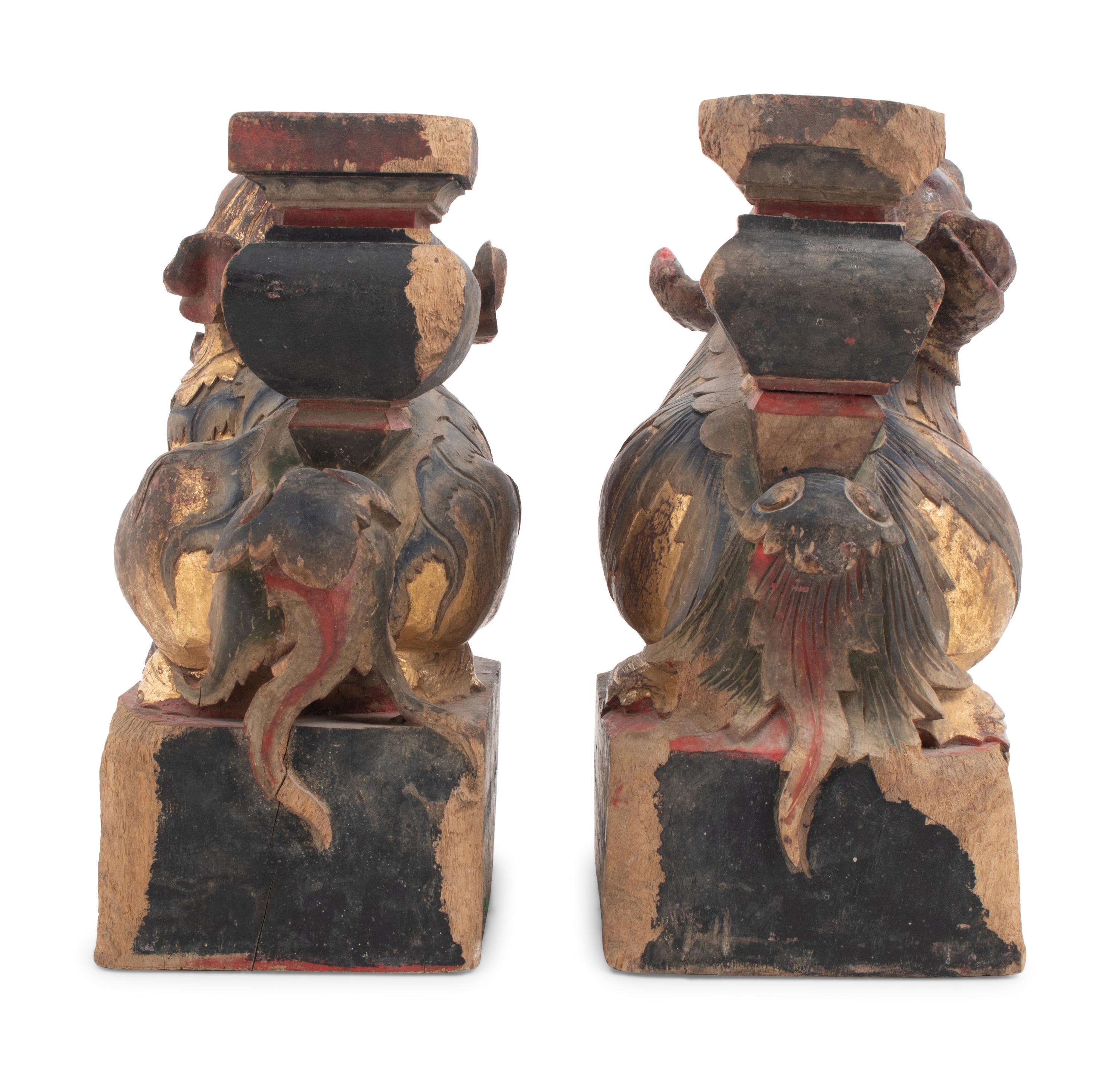 A Pair of Chinese Giltwood Candlesticks with Buddhistic Lions