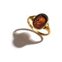 A Roman Carnelian Ring Stone with a Portrait Head of the God Cronus — Set in a gold ring