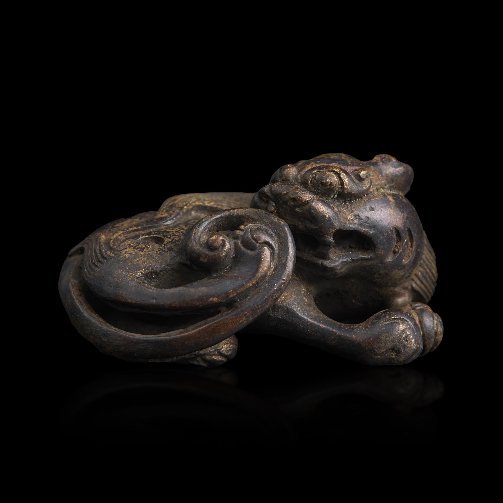 A Chinese Patinated Bronze Figure of a Stylized Lion, Late Ming-Early Qing Dynasty — 明末清初 銅獅鎮紙
