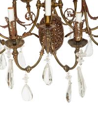 A Pierced Brass Eight-Light Chandelier with Crystal Drops