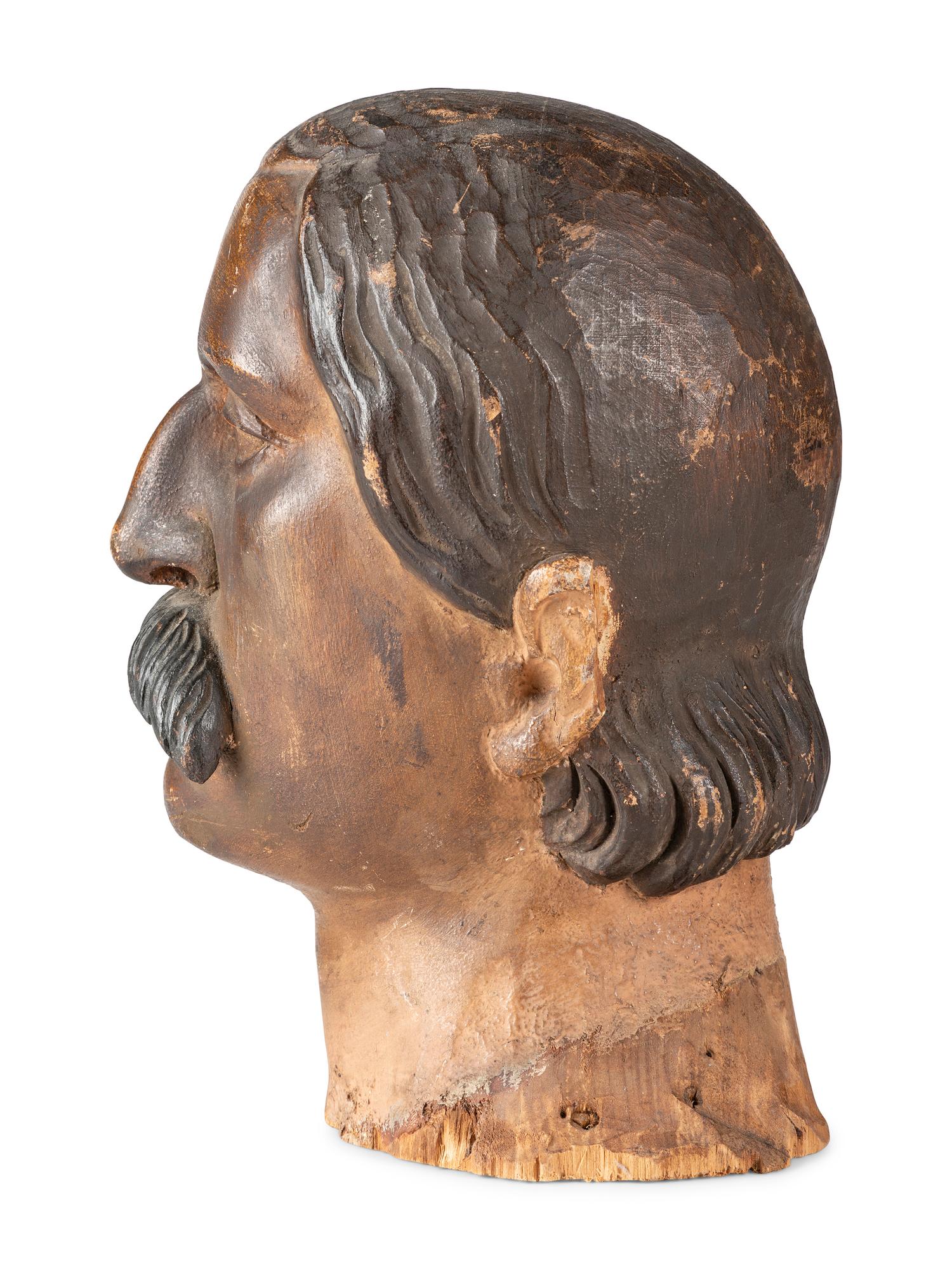 A Carved and Painted Wood Head of a Mustachioed Man