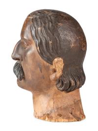 A Carved and Painted Wood Head of a Mustachioed Man