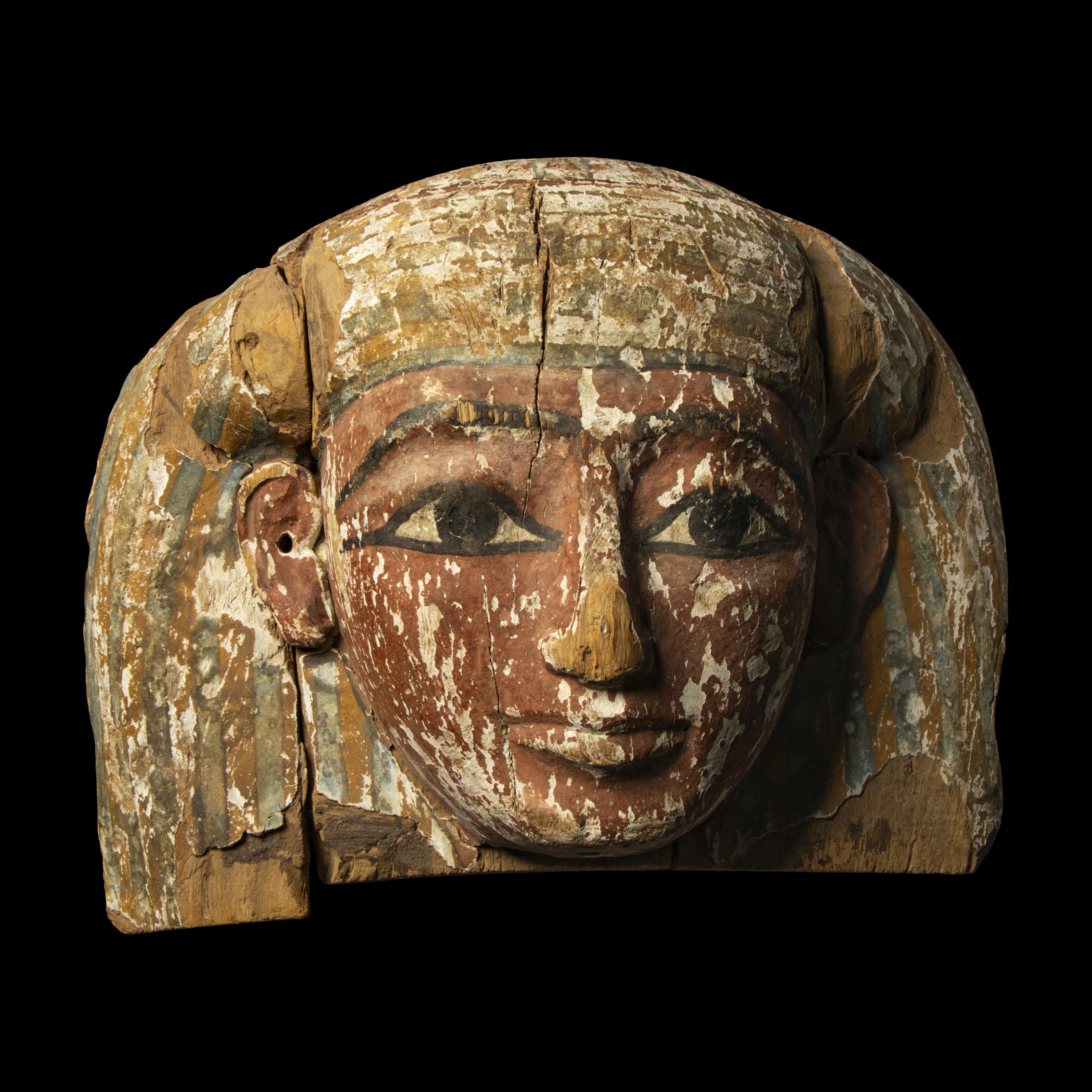 An Egyptian Painted Wood Sarcophagus Head