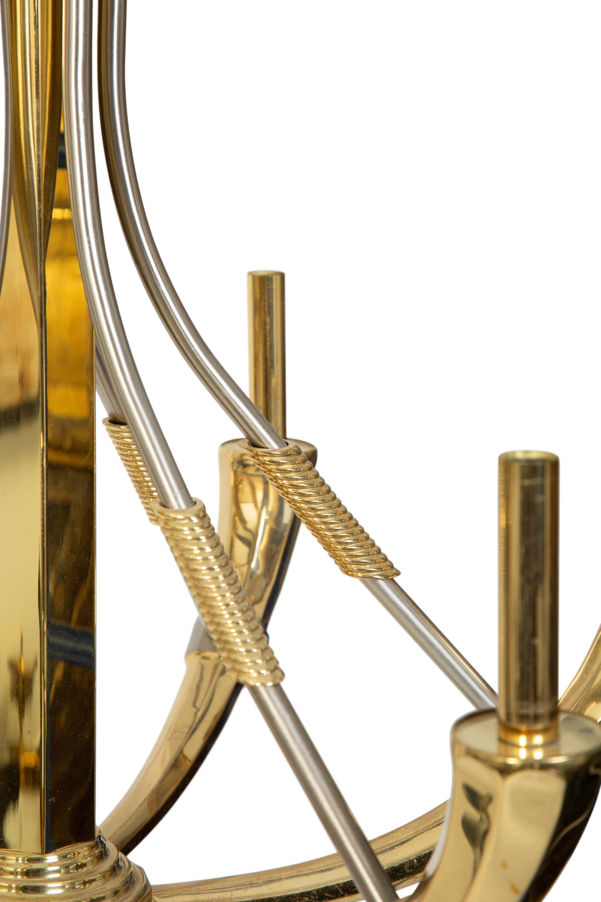 A Pair of Steel and Brass Chandeliers by Maison Jansen