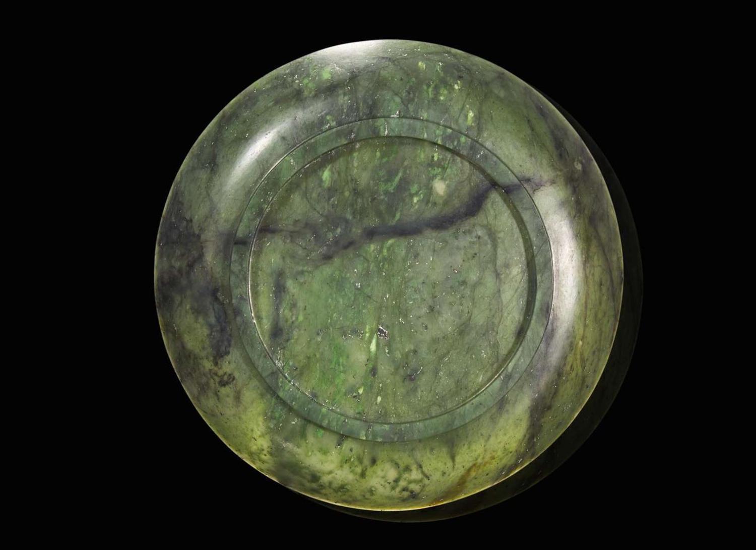 A Chinese spinach green jade circular dish, 18th / 19th century 翠玉小盤 十八或十九世紀