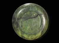 A Chinese spinach green jade circular dish, 18th / 19th century 翠玉小盤 十八或十九世紀