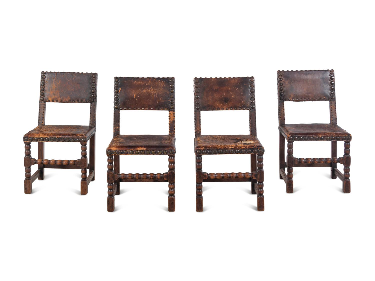 A Set of Four Spanish Baroque Style Oak Chairs with Leather Upholstery