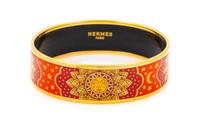 An Hermès Red and Orange Enamel 65mm Bangle, 2.5" diameter, .75" W.