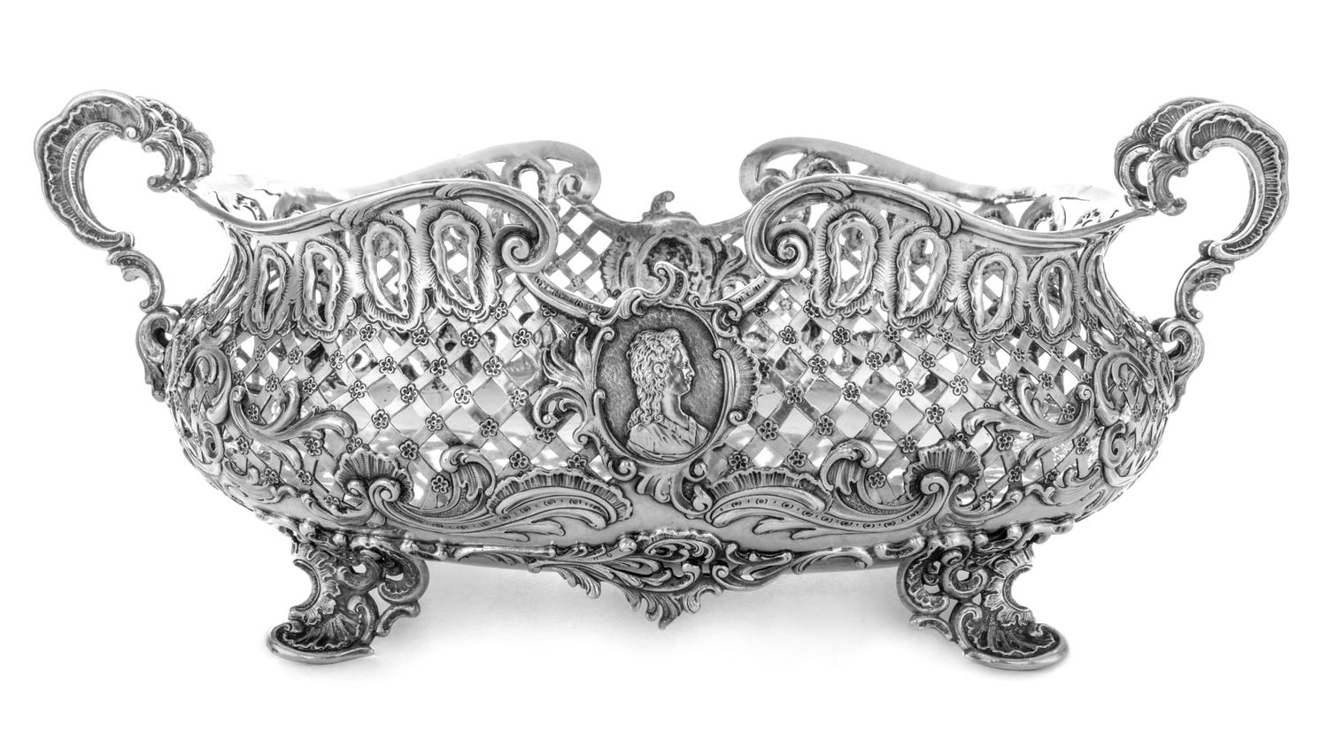A German Silver Centerpiece Basket, George Roth & Co., Hanau, Late 19th Century, having pierced sides and profile medallions with rocai