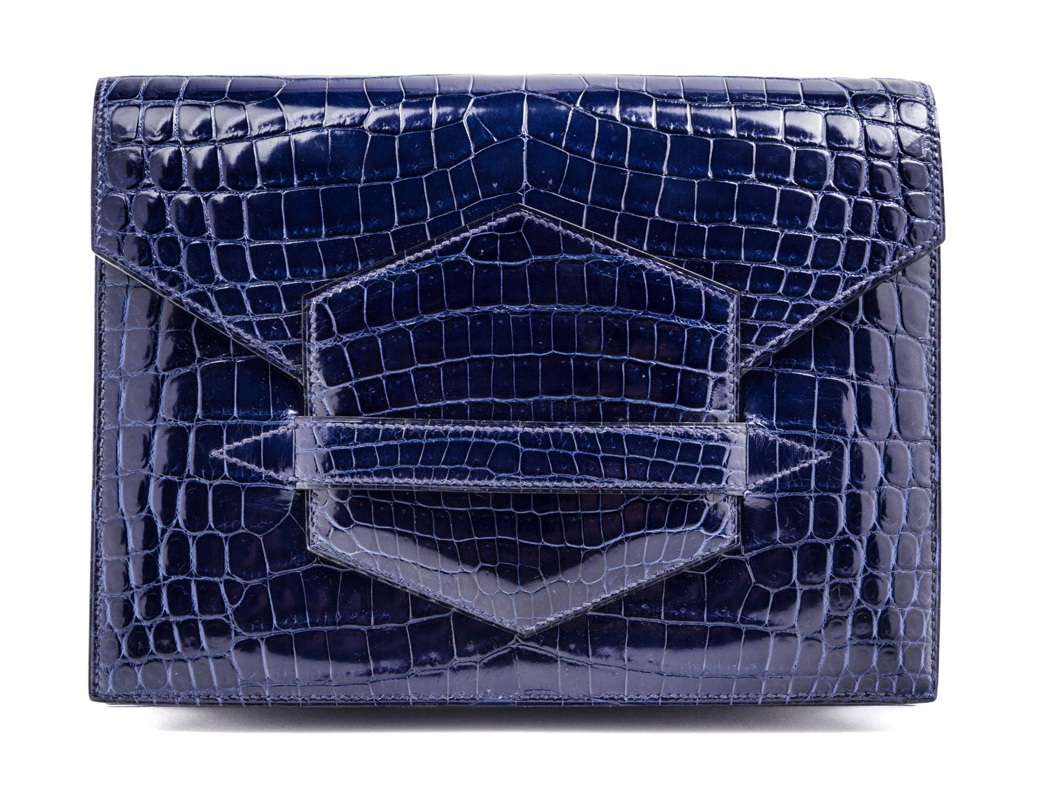 An Hermes Navy Niloticus Crocodile Faco Clutch, 9.25" x 7" x 1".