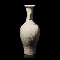 A Chinese White Glazed Soft Paste Molded 'Dragons and Lingzhi' Vase, 18th Century 清中期 白釉模印漿胎靈芝螭龍紋瓶