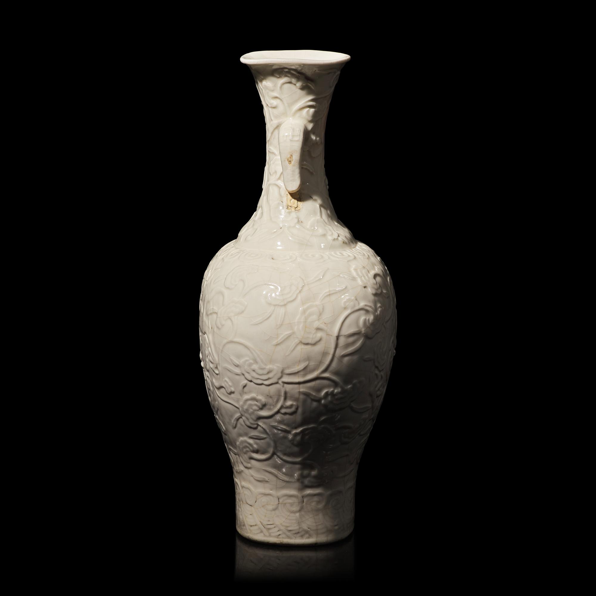 A Chinese White Glazed Soft Paste Molded 'Dragons and Lingzhi' Vase, 18th Century 清中期 白釉模印漿胎靈芝螭龍紋瓶