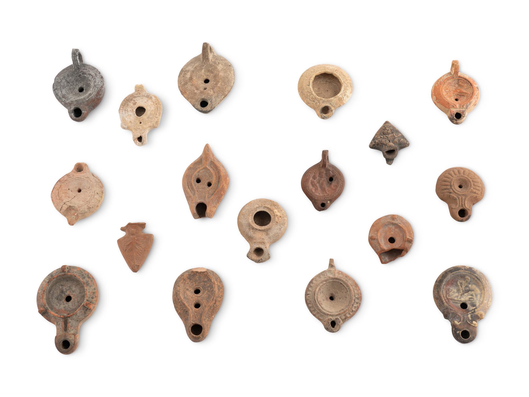 A Group of Seventeen Roman Oil Lamps and Lamp Handles