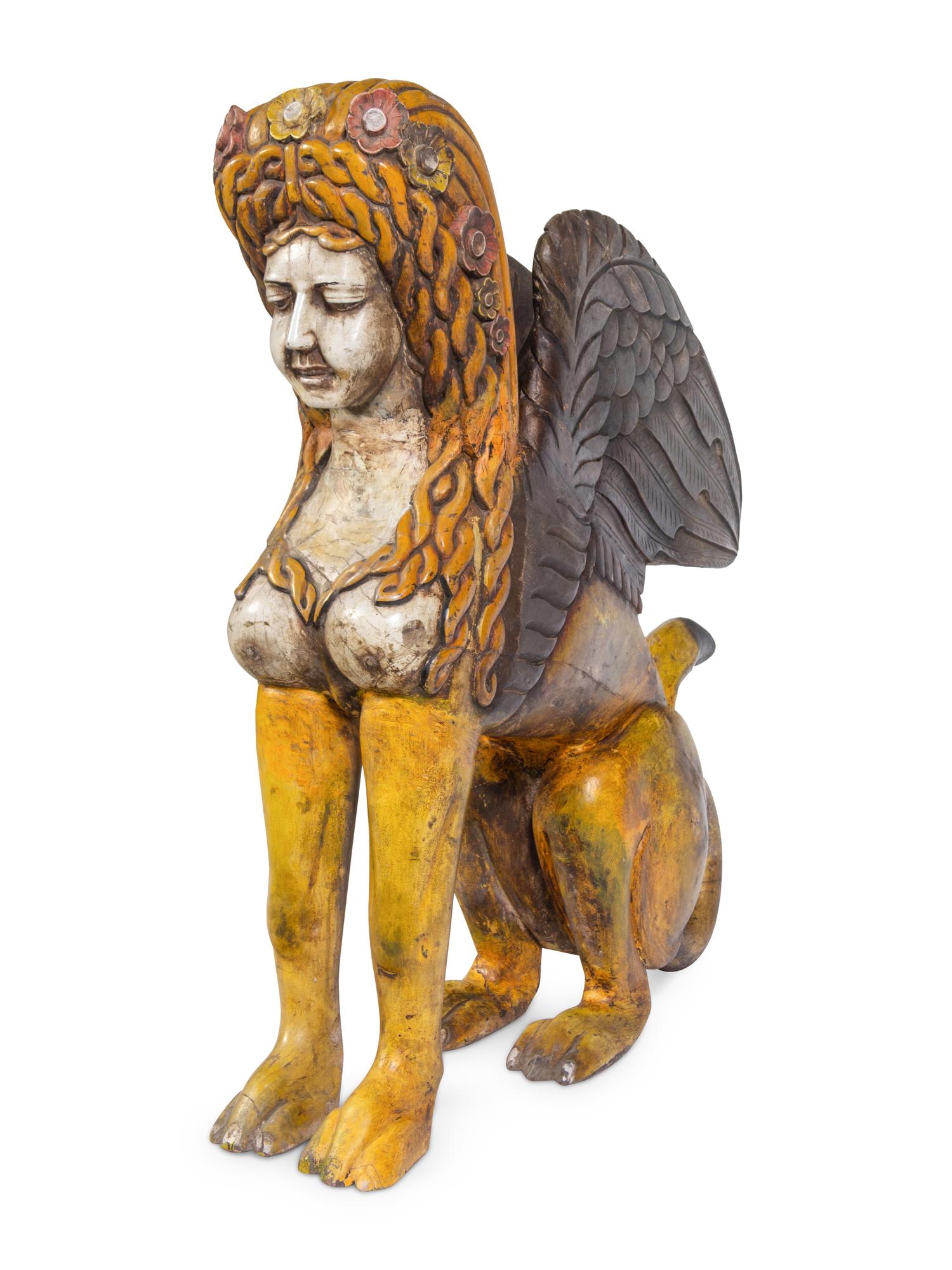 A Large Carved and Polychrome Decorated Wood Sphinx