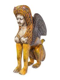 A Large Carved and Polychrome Decorated Wood Sphinx