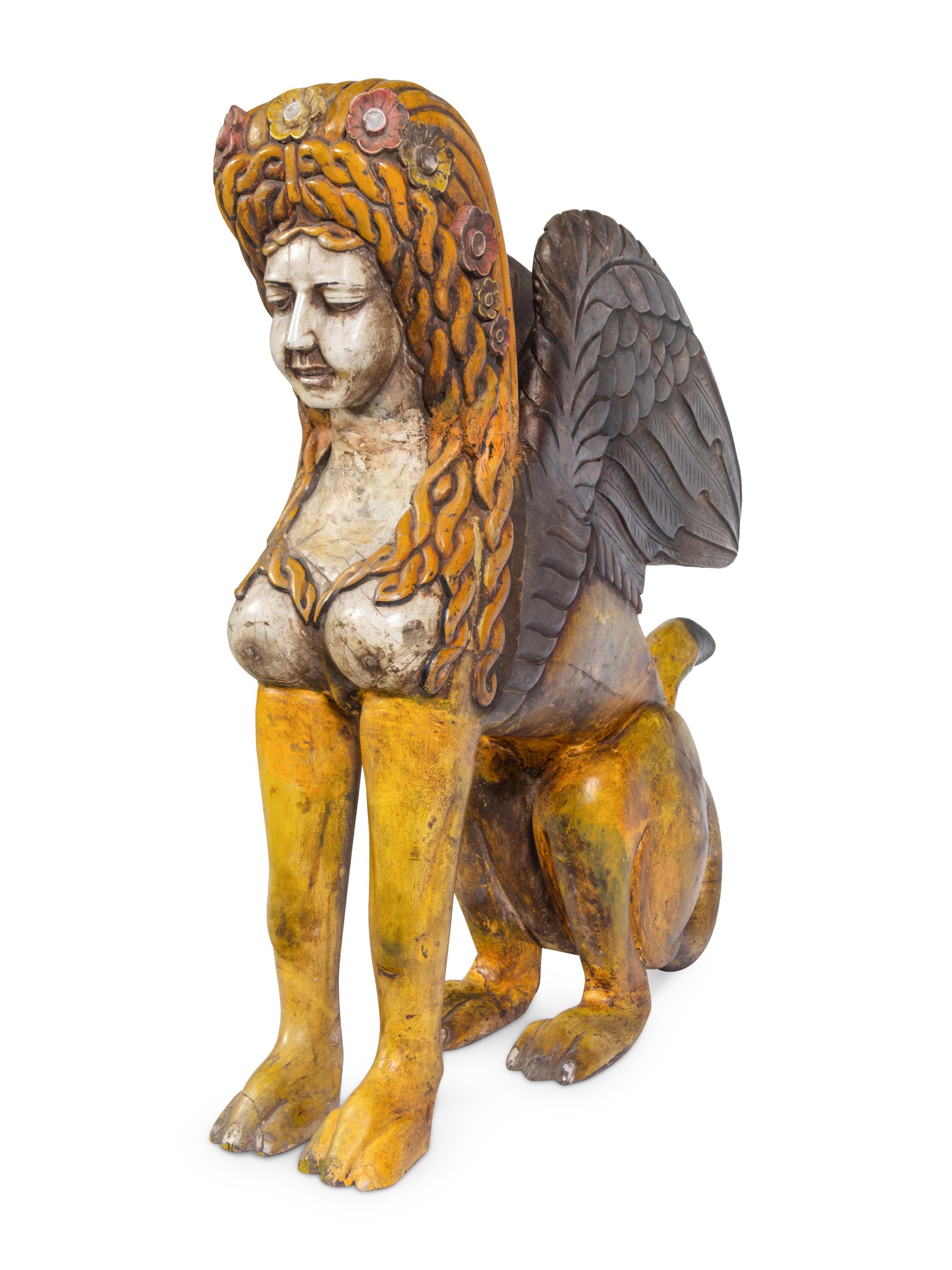 A Large Carved and Polychrome Decorated Wood Sphinx