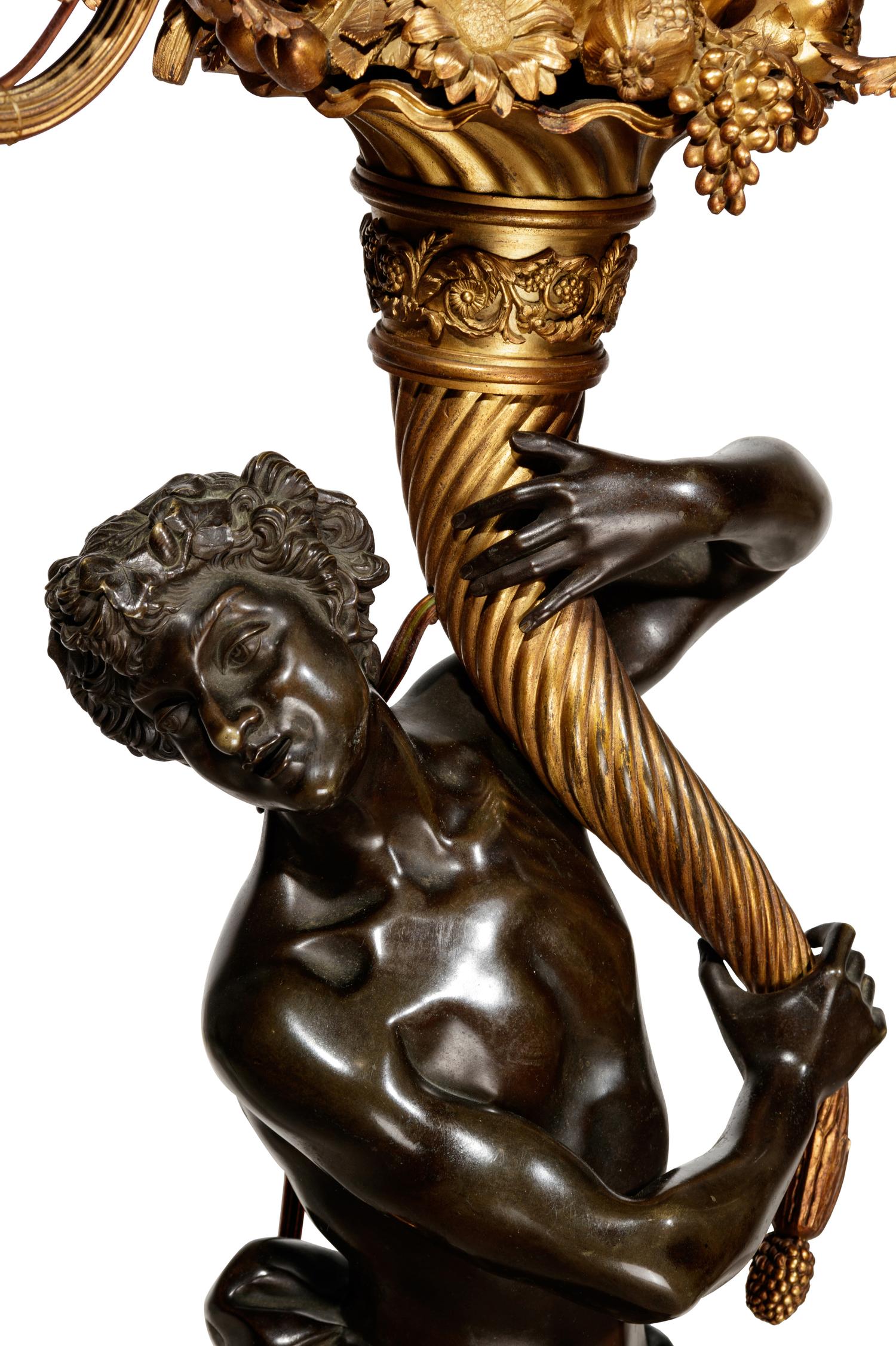 A Pair of Large Gilt and Patinated Bronze Figural Nine-Light Candelabra after the Models by Clodion