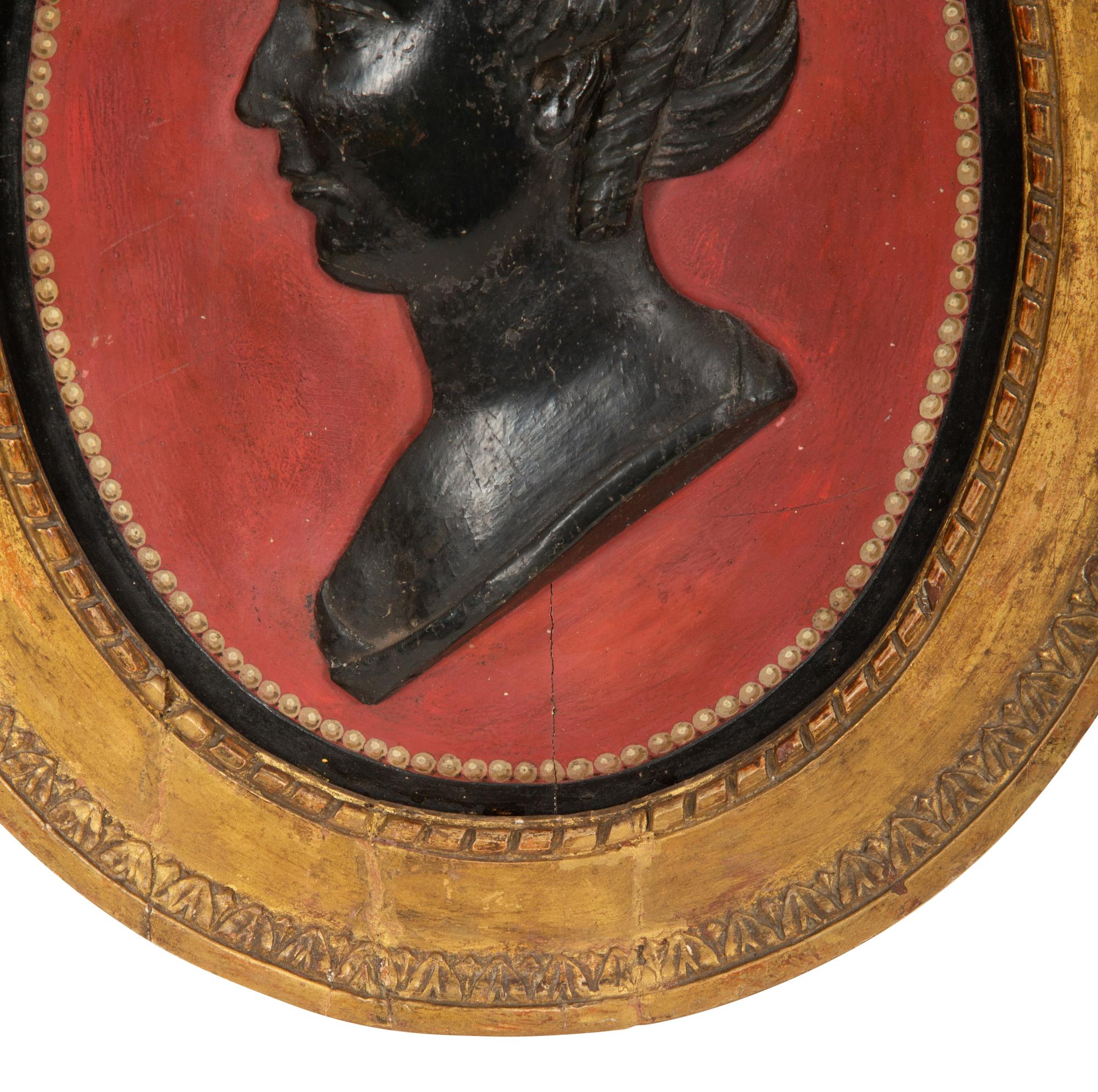 A Pair of Giltwood Framed Ebonized Relief Portrait Plaques of French Nobility, 18th Century