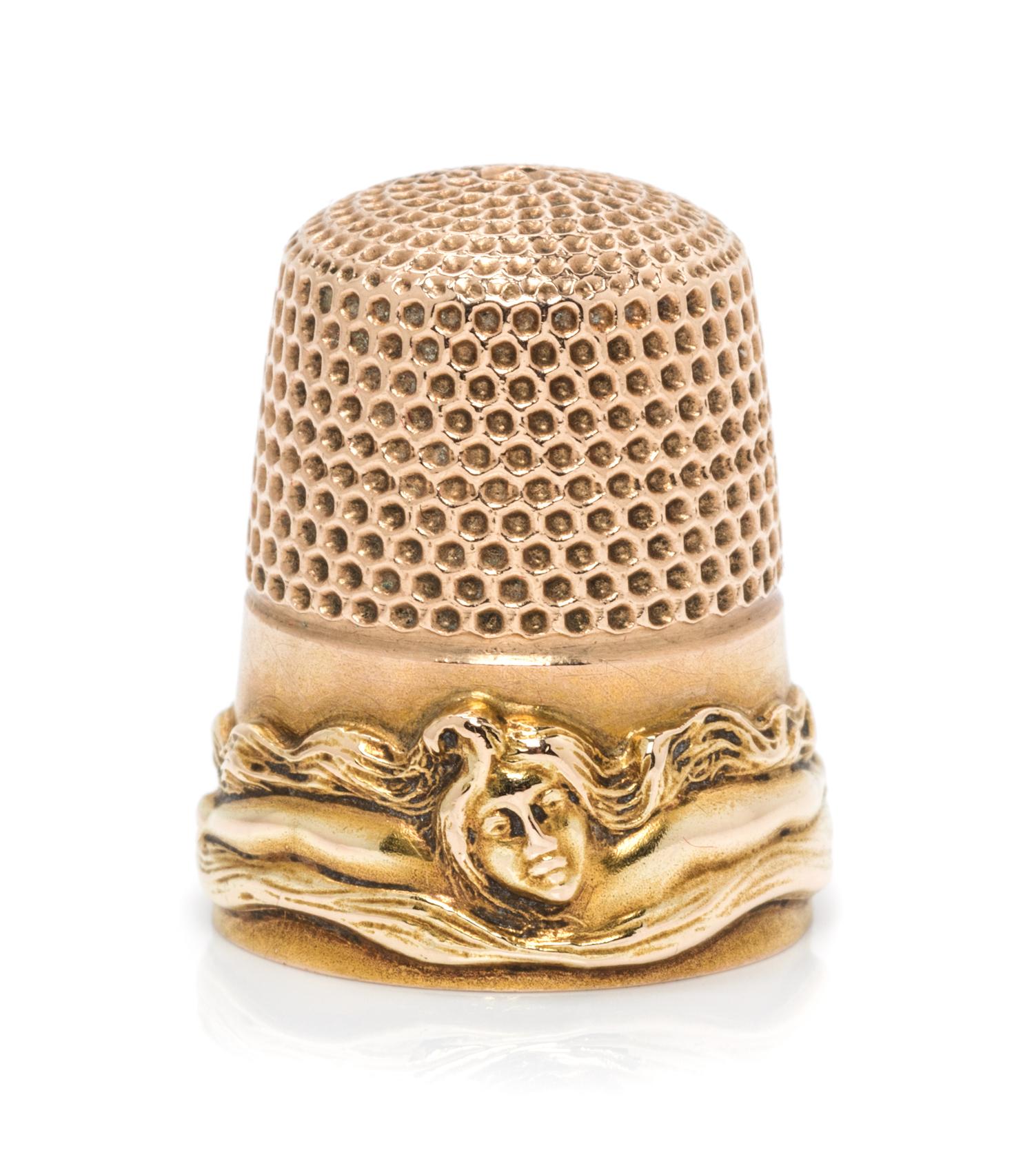 An American 14-Karat Gold Femme Fleur Thimble, Goldsmith, Stern & Co., New York, NY, the knurled top and body above a band worked to sh