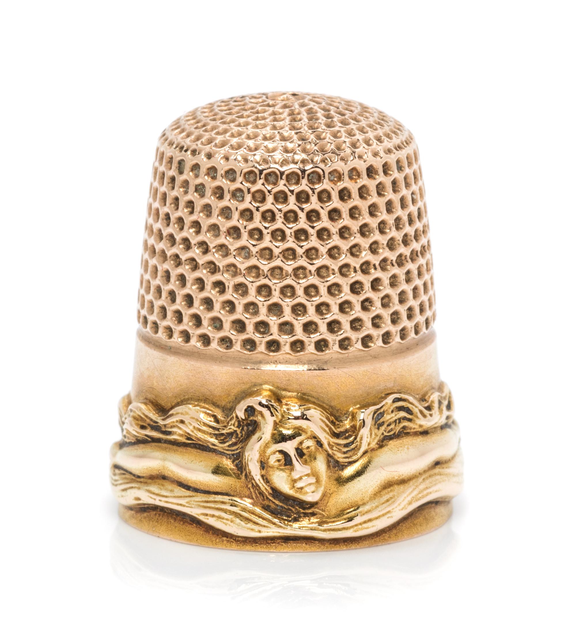 An American 14-Karat Gold Femme Fleur Thimble, Goldsmith, Stern & Co., New York, NY, the knurled top and body above a band worked to sh