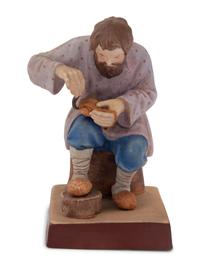 A Russian Porcelain Figure of a Bast Shoe Maker
